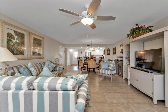 living room featuring ceiling fan with notable chandelier