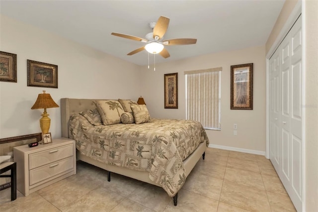 bedroom with light tile patterned floors, ceiling fan, and a closet