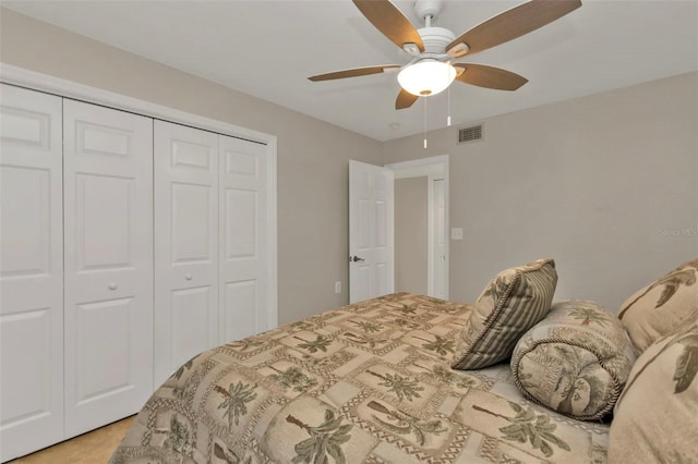 bedroom with ceiling fan and a closet