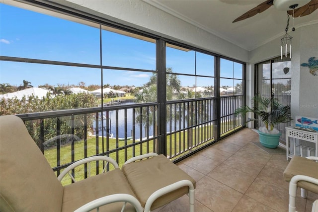 sunroom / solarium featuring ceiling fan, plenty of natural light, and a water view