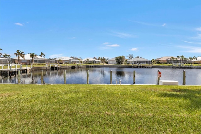 dock area featuring a yard and a water view