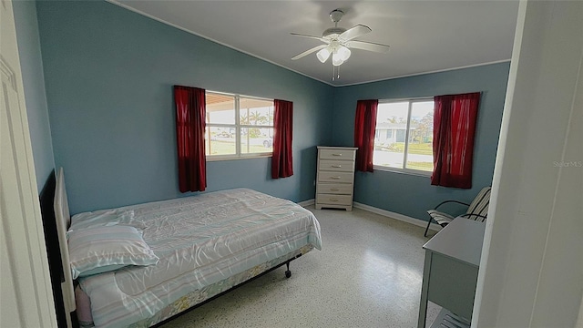554 Lindley Ter, Port Charlotte, FL 33952 - bedroom with multiple windows, baseboards, vaulted ceiling, ceiling fan, and dark aggregate flooring