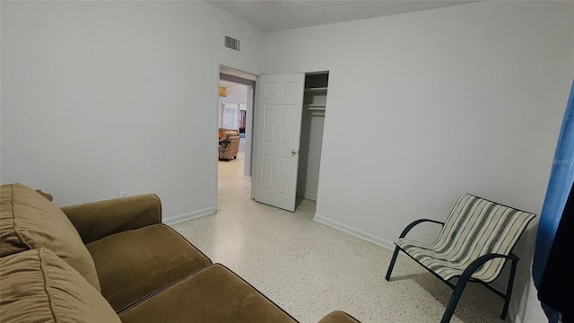 554 Lindley Ter, Port Charlotte, FL 33952 - living area featuring baseboards and dark aggregate flooring