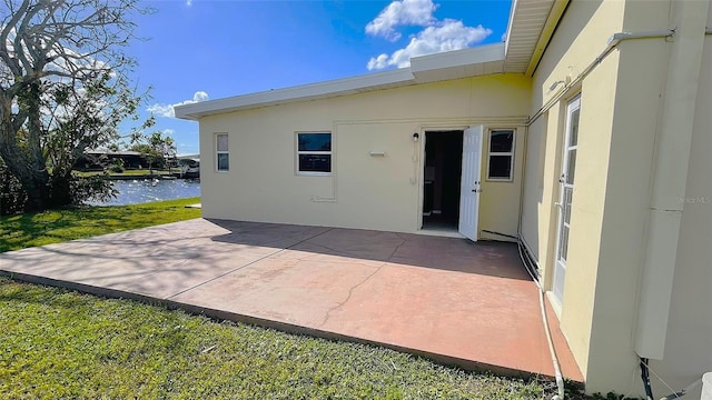 554 Lindley Ter, Port Charlotte, FL 33952 - back of house featuring a patio area, a water view, and stucco siding