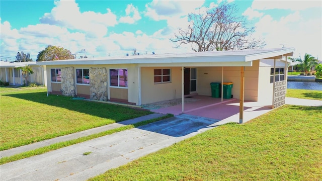 554 Lindley Ter, Port Charlotte, FL 33952 - rear view of house featuring concrete driveway, an attached carport, and a yard