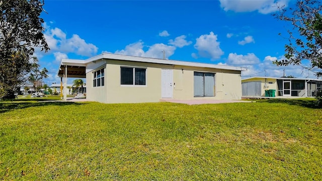 back of property featuring a lawn