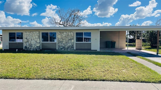 ranch-style house with a front yard and a carport