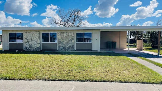 554 Lindley Ter, Port Charlotte, FL 33952 - ranch-style house with stone siding, a carport, and a front yard