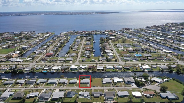 554 Lindley Ter, Port Charlotte, FL 33952 - aerial view of property and surrounding area with property parcel outlined, a large body of water, and nearby suburban area