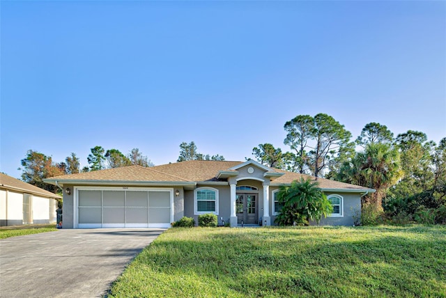 single story home with a garage and a front lawn