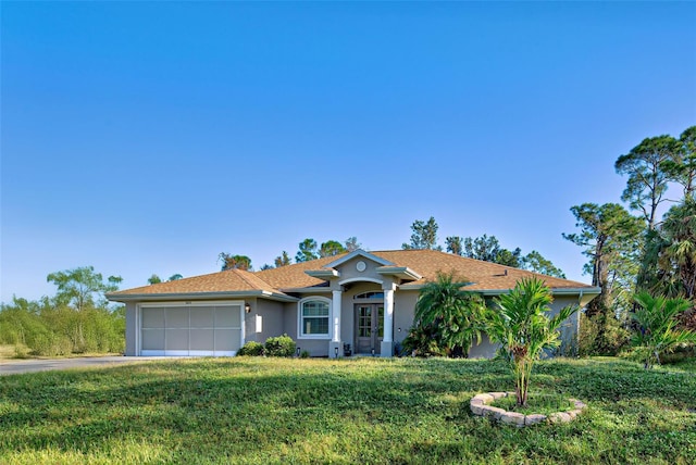 ranch-style home featuring a front lawn and a garage