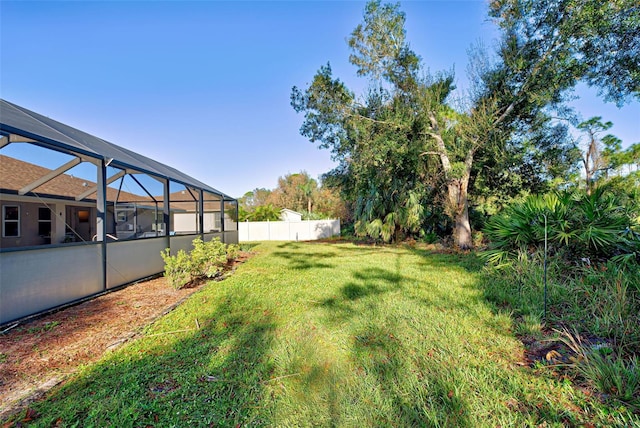 view of yard featuring glass enclosure