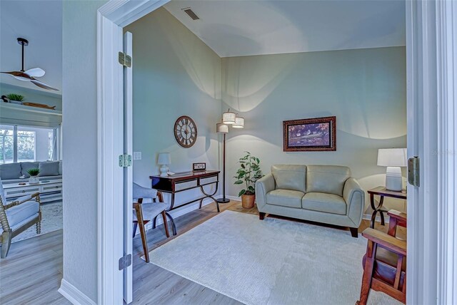 living room featuring light hardwood / wood-style floors and lofted ceiling