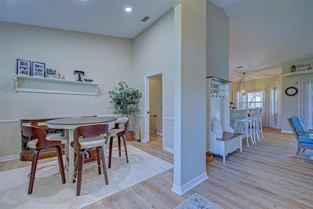 dining space with a chandelier and light wood-type flooring