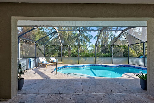 view of pool with a lanai and a patio area