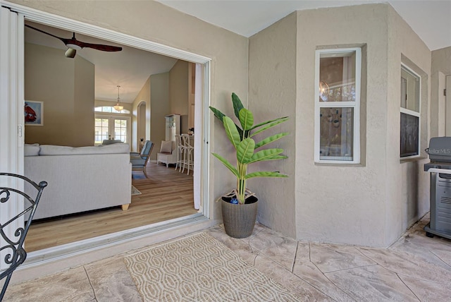 doorway to property with ceiling fan