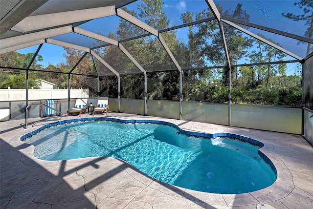 view of pool featuring a patio and glass enclosure