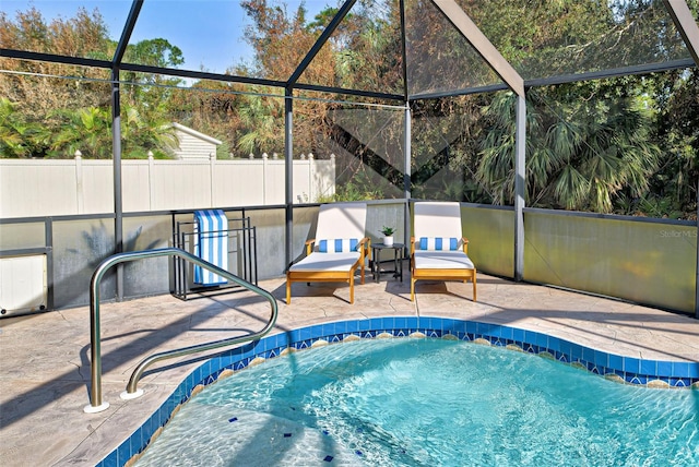 view of swimming pool with a patio and glass enclosure