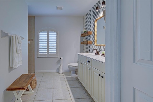 bathroom featuring toilet, a shower, vanity, and tile patterned floors