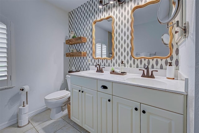 bathroom with tile patterned floors, plenty of natural light, vanity, and toilet