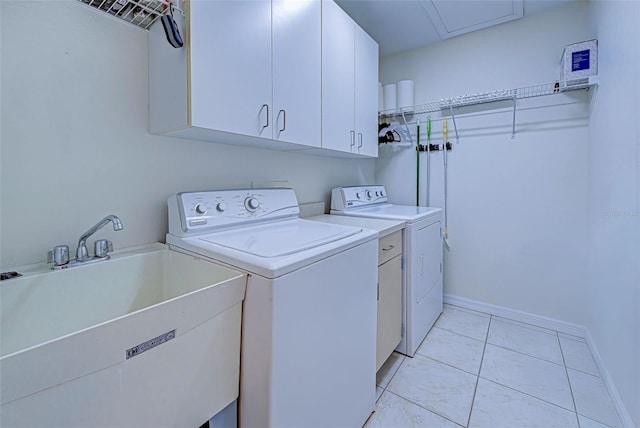 clothes washing area featuring cabinets, separate washer and dryer, and sink