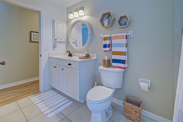 bathroom featuring vanity, hardwood / wood-style flooring, and toilet