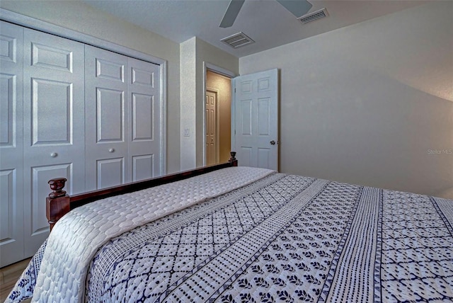 bedroom with wood-type flooring, a closet, and ceiling fan