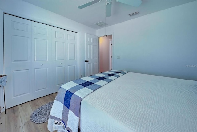 bedroom featuring ceiling fan, a closet, and light hardwood / wood-style floors