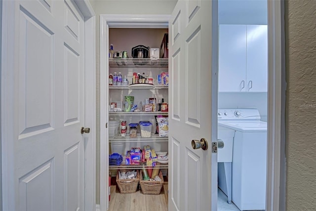 pantry featuring washer and dryer