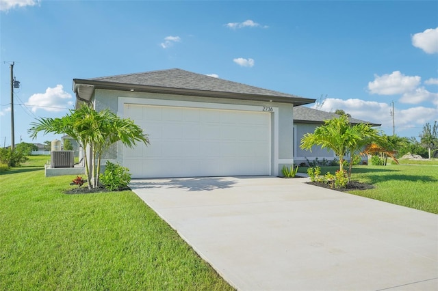 view of front of home with central air condition unit, a garage, and a front lawn