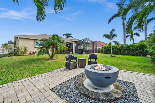 view of patio / terrace with a sunroom and a fire pit