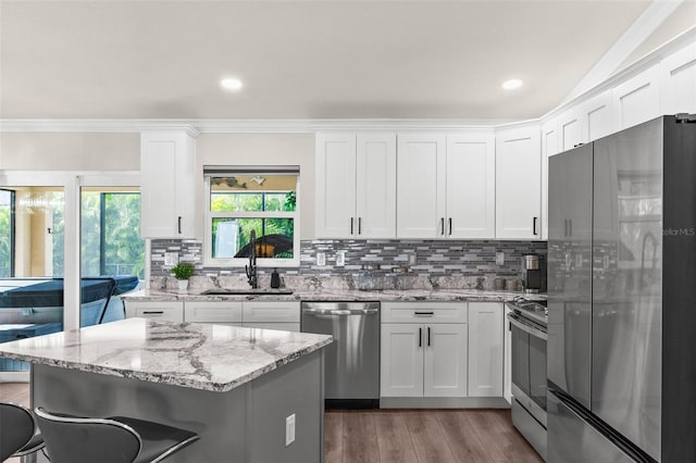 kitchen with stainless steel appliances, white cabinetry, and sink