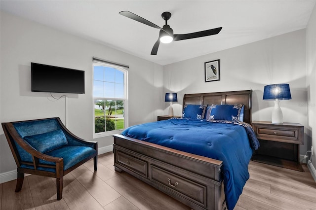 bedroom with light hardwood / wood-style flooring and ceiling fan