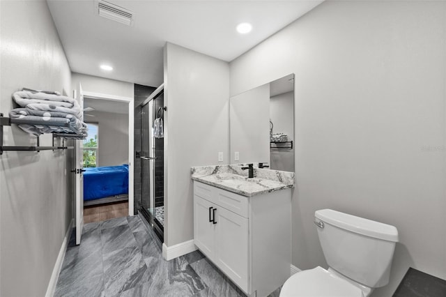 bathroom with vanity, toilet, and an enclosed shower