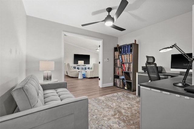 home office with ceiling fan, wood-type flooring, and lofted ceiling