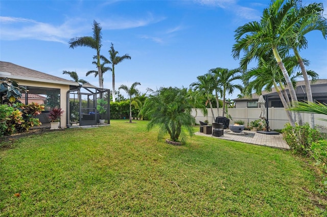 view of yard with a lanai and a patio