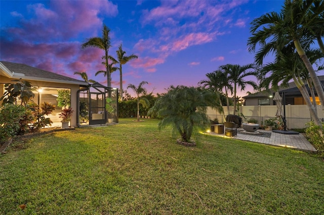 yard at dusk with a patio and a lanai