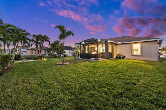 yard at dusk with a sunroom and a lanai