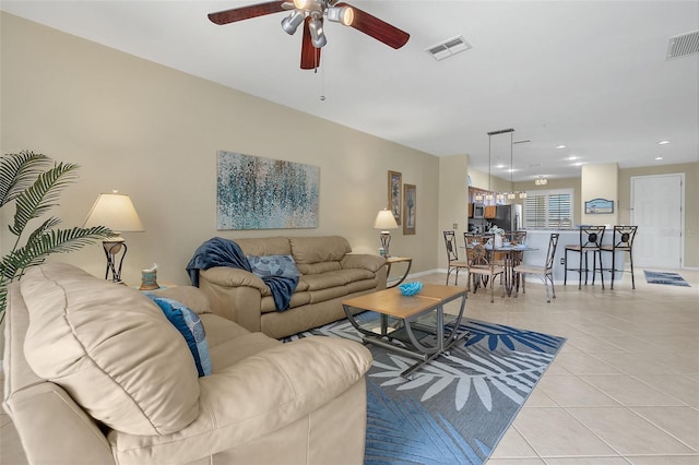 living room featuring light tile patterned floors and ceiling fan