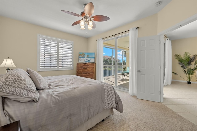 tiled bedroom featuring access to outside, multiple windows, and ceiling fan