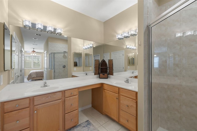 bathroom featuring an enclosed shower, vanity, and tile patterned flooring