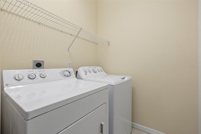 clothes washing area with independent washer and dryer