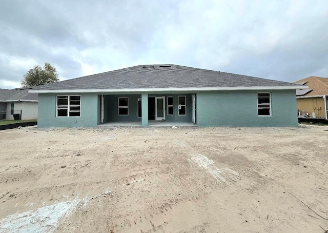 back of house featuring stucco siding