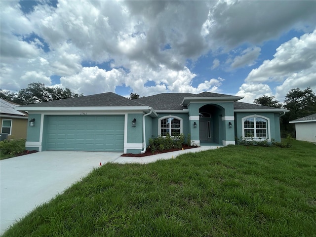 27462 Pasto Dr, Punta Gorda, FL 33983 - ranch-style home with stucco siding, a front lawn, an attached garage, driveway, and roof with shingles