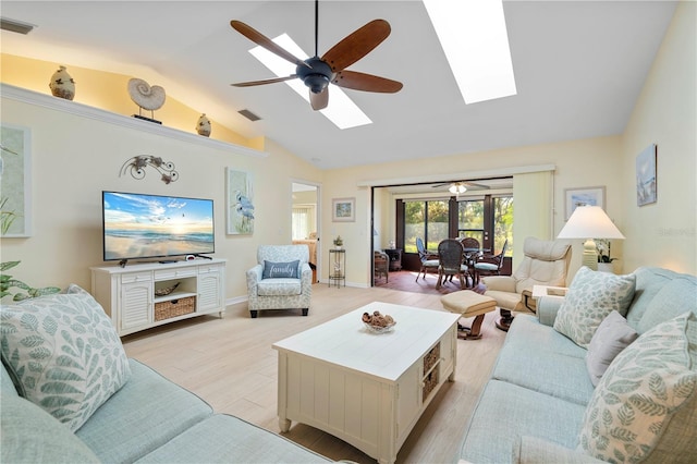 living room featuring ceiling fan, light wood-type flooring, and vaulted ceiling