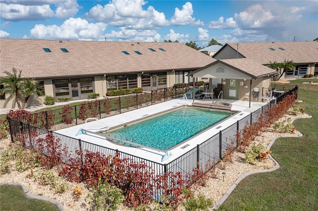 view of pool featuring a patio area and a yard