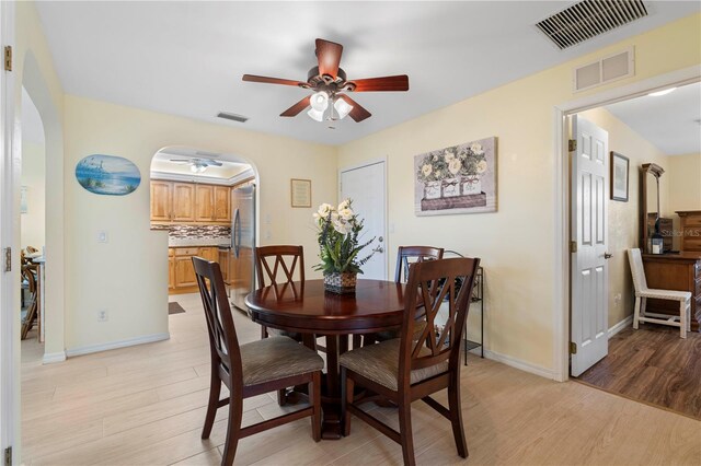 dining area with ceiling fan and light wood-type flooring