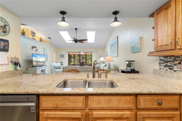 kitchen featuring hanging light fixtures, sink, and lofted ceiling with skylight