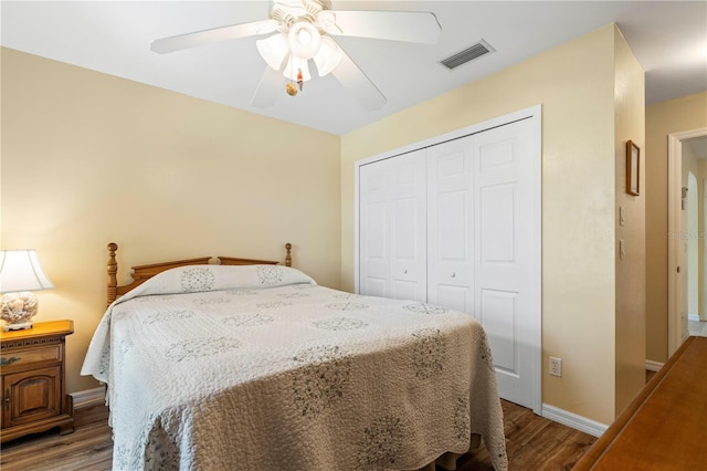 bedroom featuring hardwood / wood-style flooring, ceiling fan, and a closet