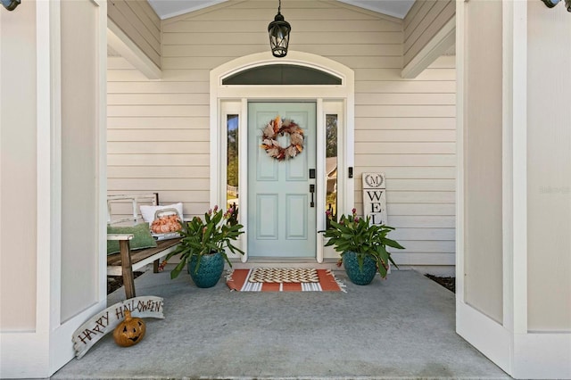 view of exterior entry with covered porch